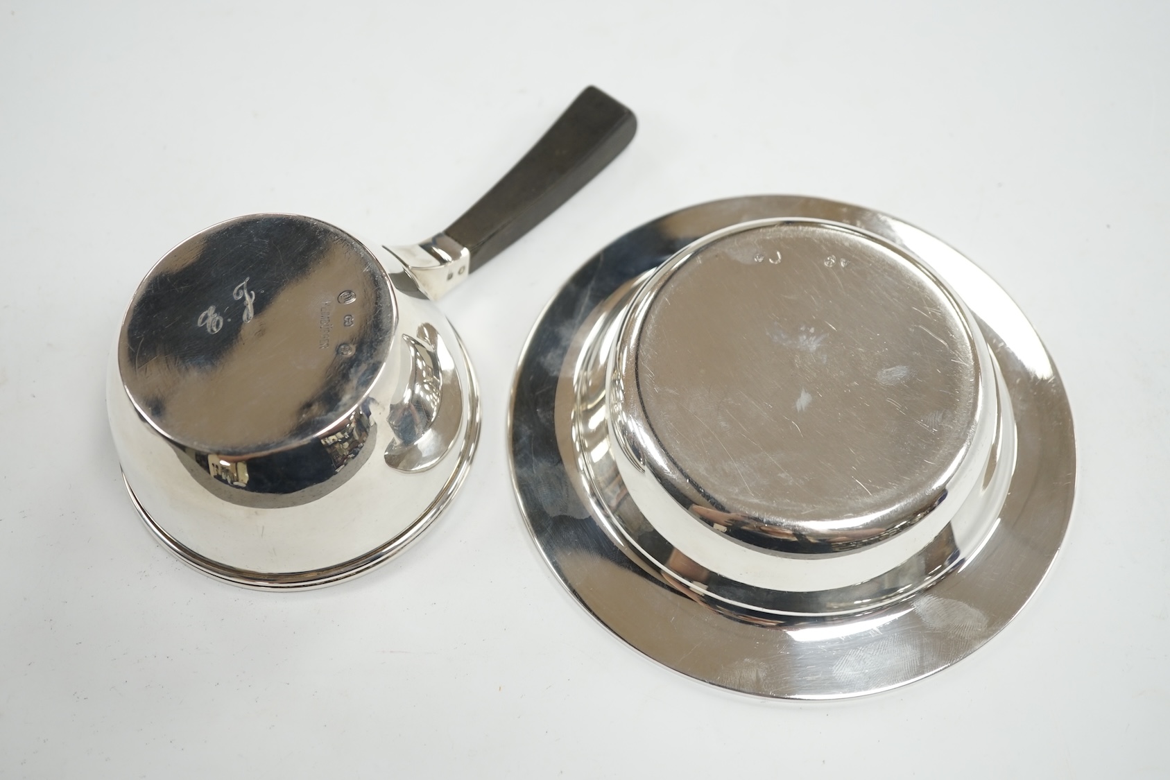 A 1940's Danish white metal bowl and small saucepan with wooden handle, the latter stamped Heimburger, gross 8.4oz. Condition - fair